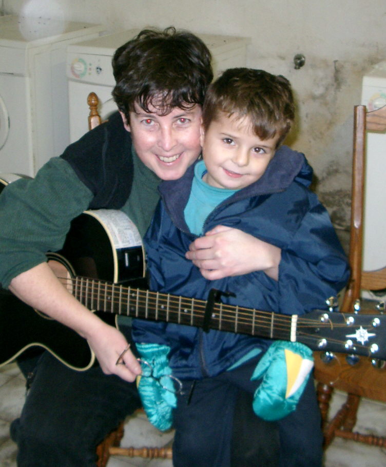 Cropped liz with young boy wearing new coat and mittens received from 2003 donations